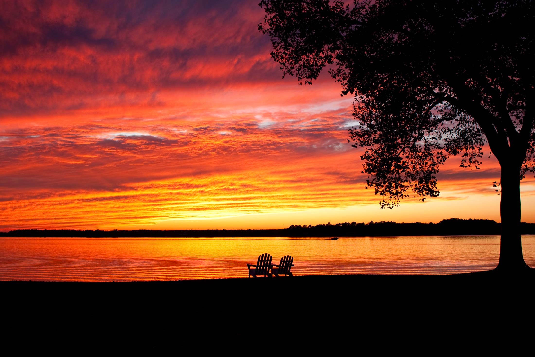 Red and orange sunset over the water at Sandaway Suites & Beach