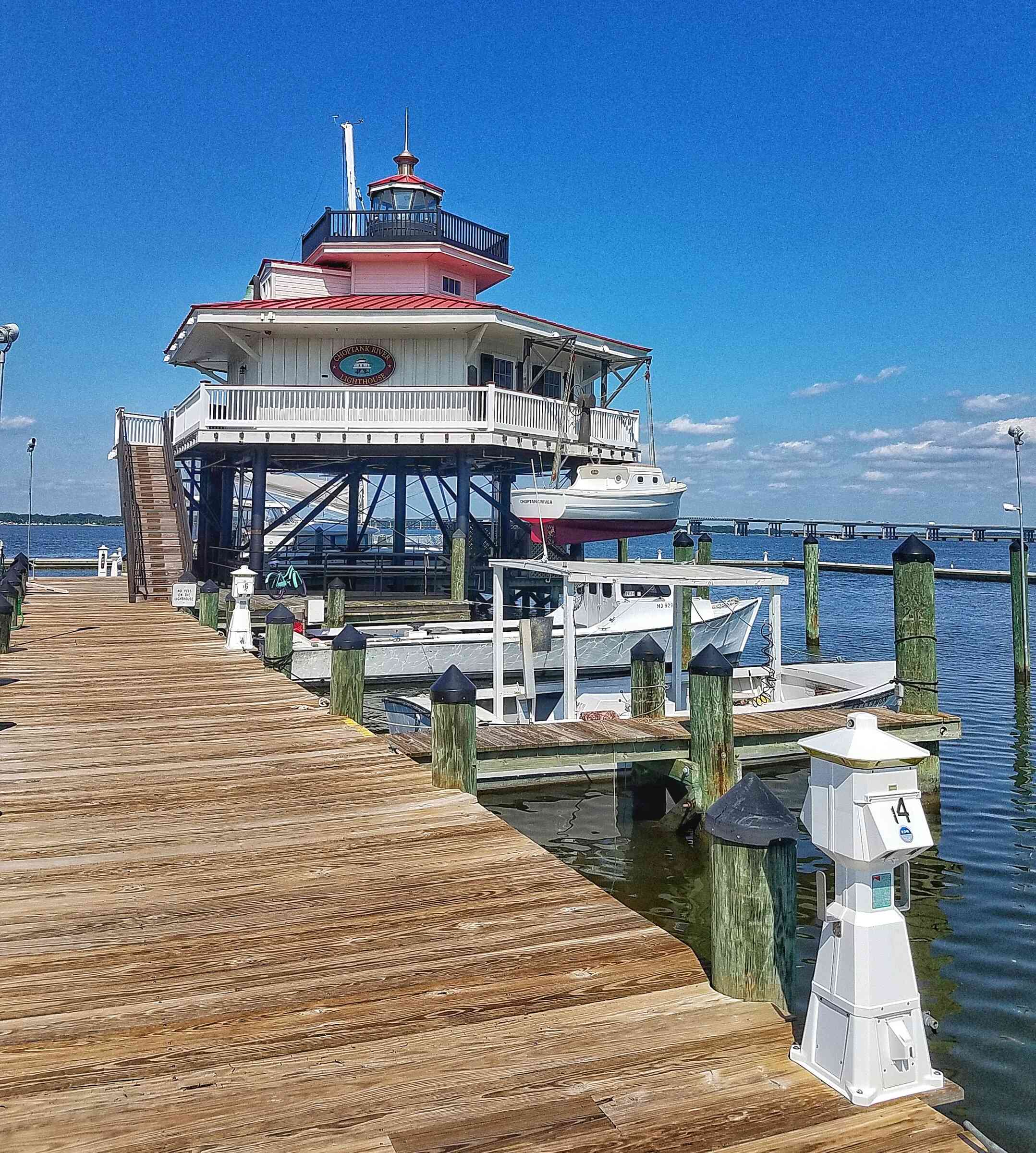 Wooden pier with Lighthouse at the end by the waterfront