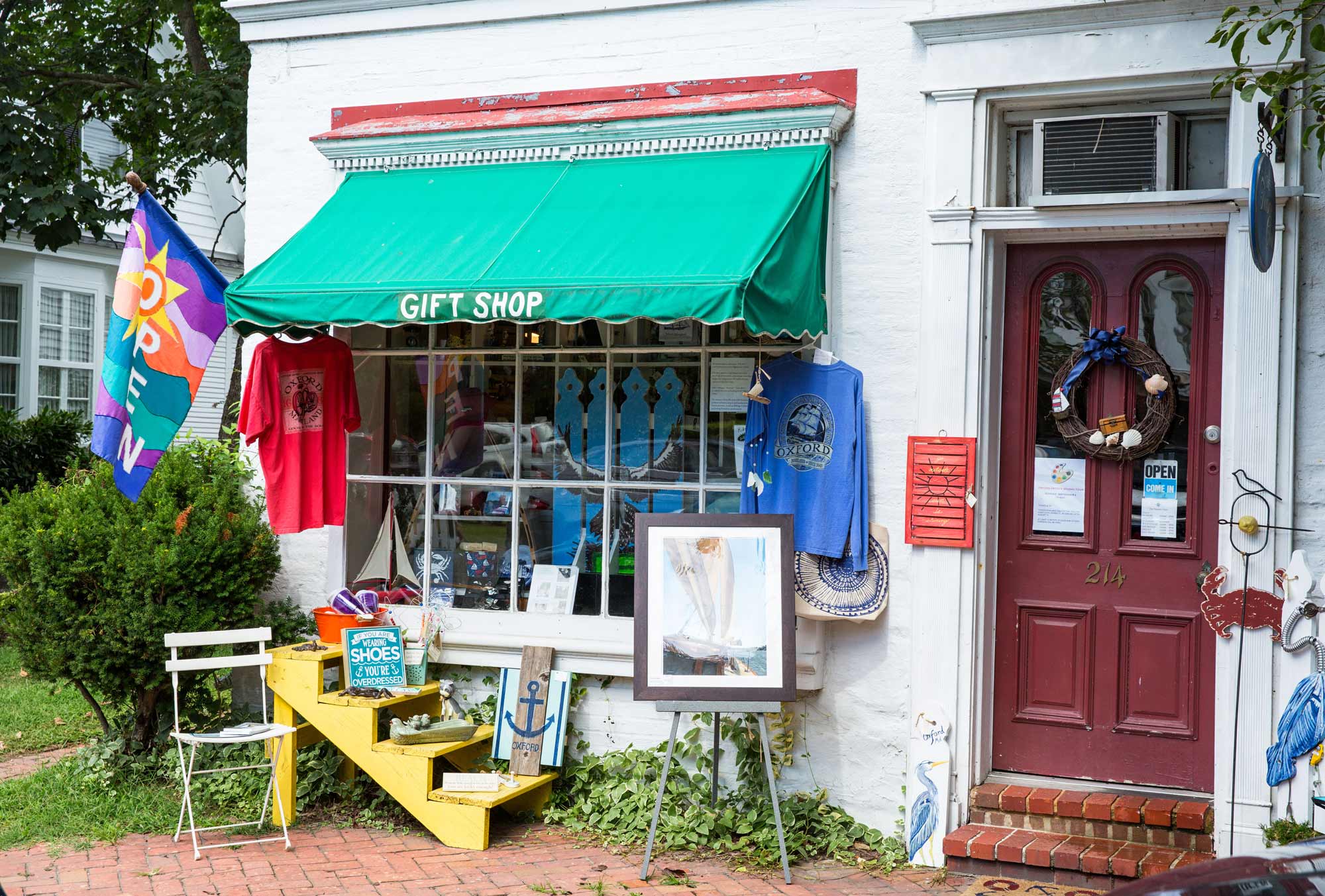 Cute shop with a green awning along a brick sidewalk