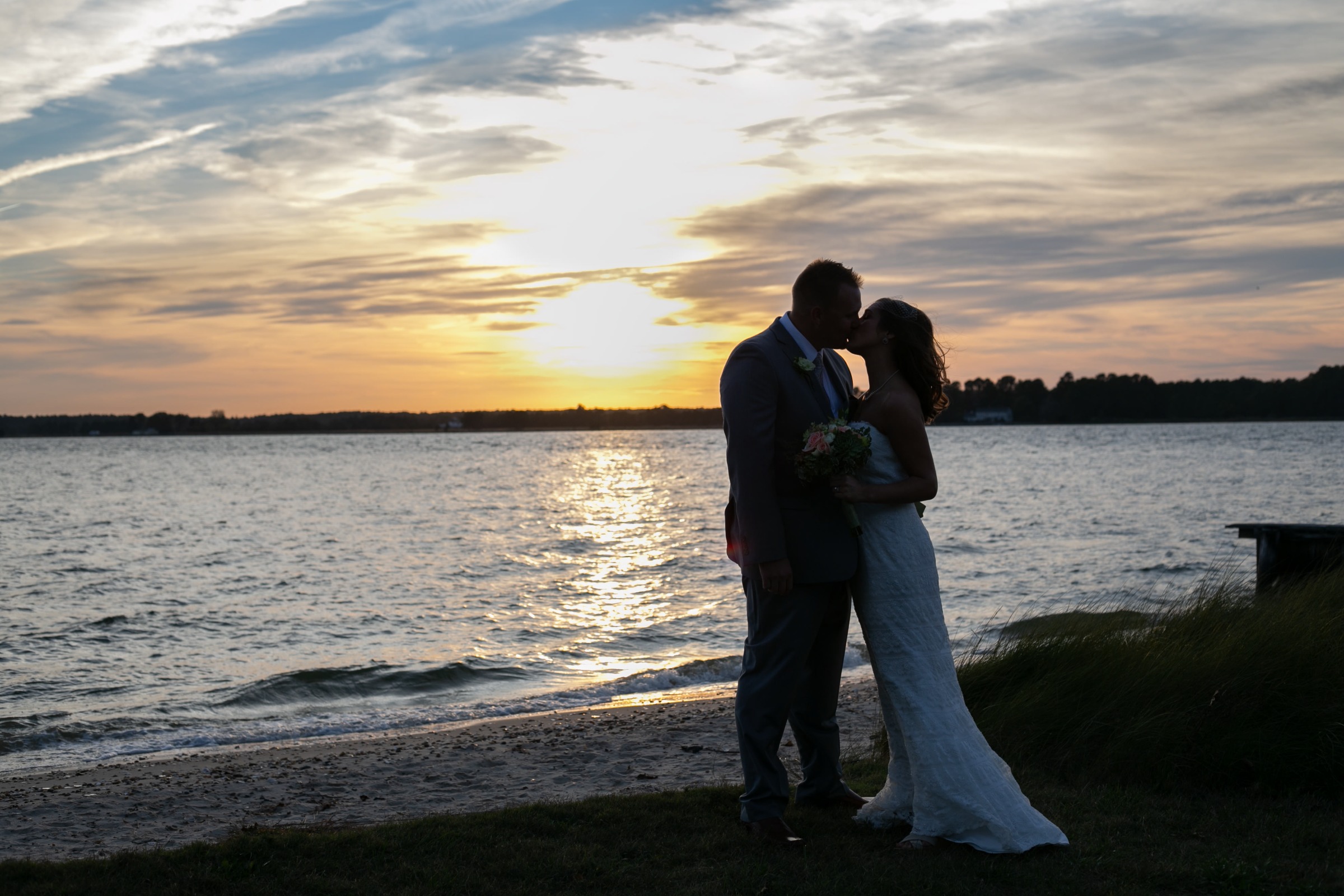 Couple getting married in Oxford, Maryland at Sandaway Suites & Beach at sunset